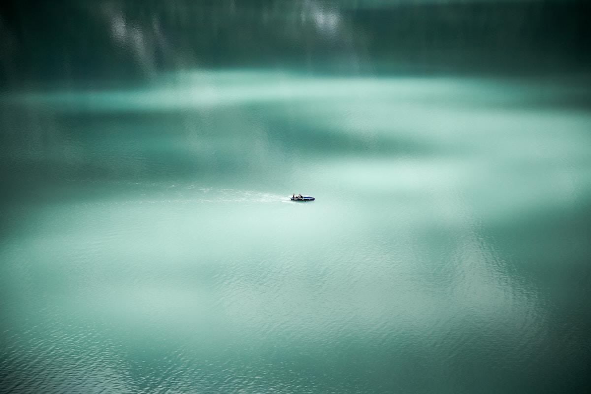 Lake with a small boat from a distance